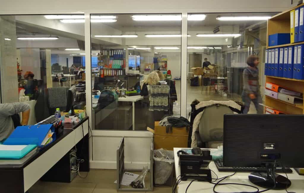 Dozens of desks, chairs, computers, shelves, drawers, files, printed material, pots, pictures in frames, notes, drawings...