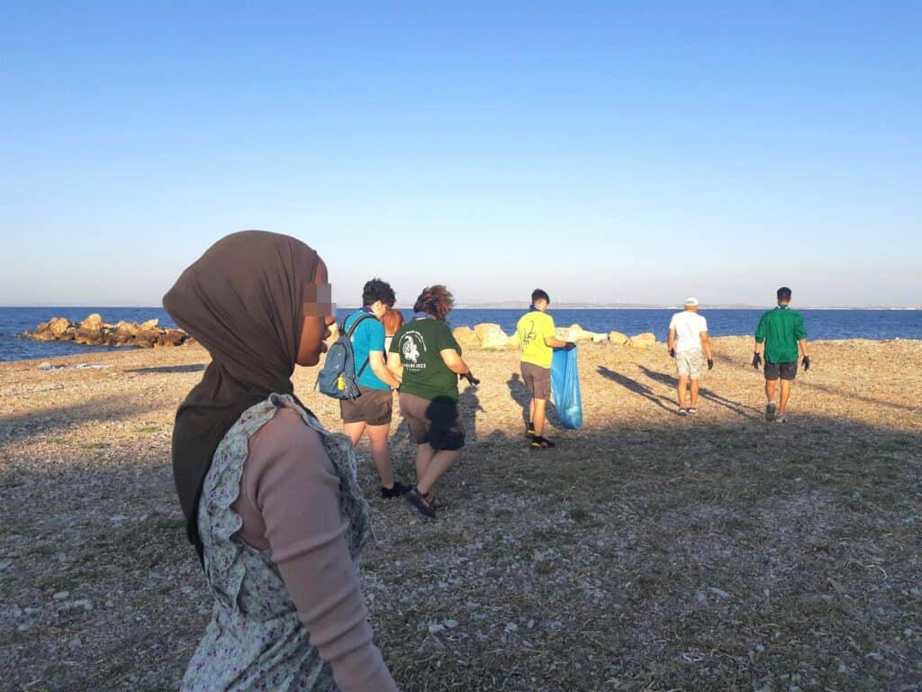 The unaccompanied children clean a beach in Chios